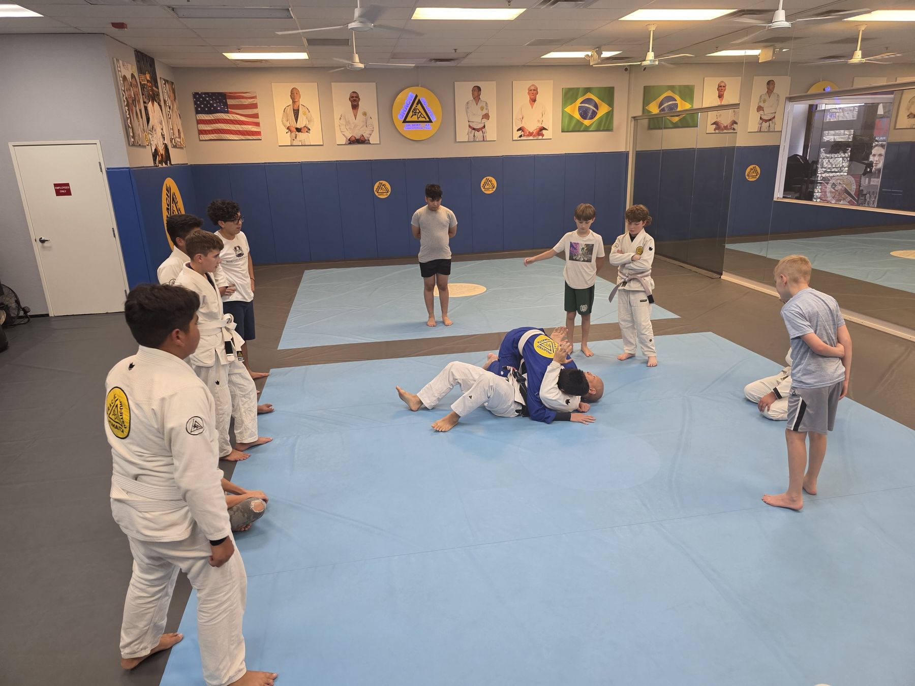 Professor Quan Phu coaching Moreana students on the mats